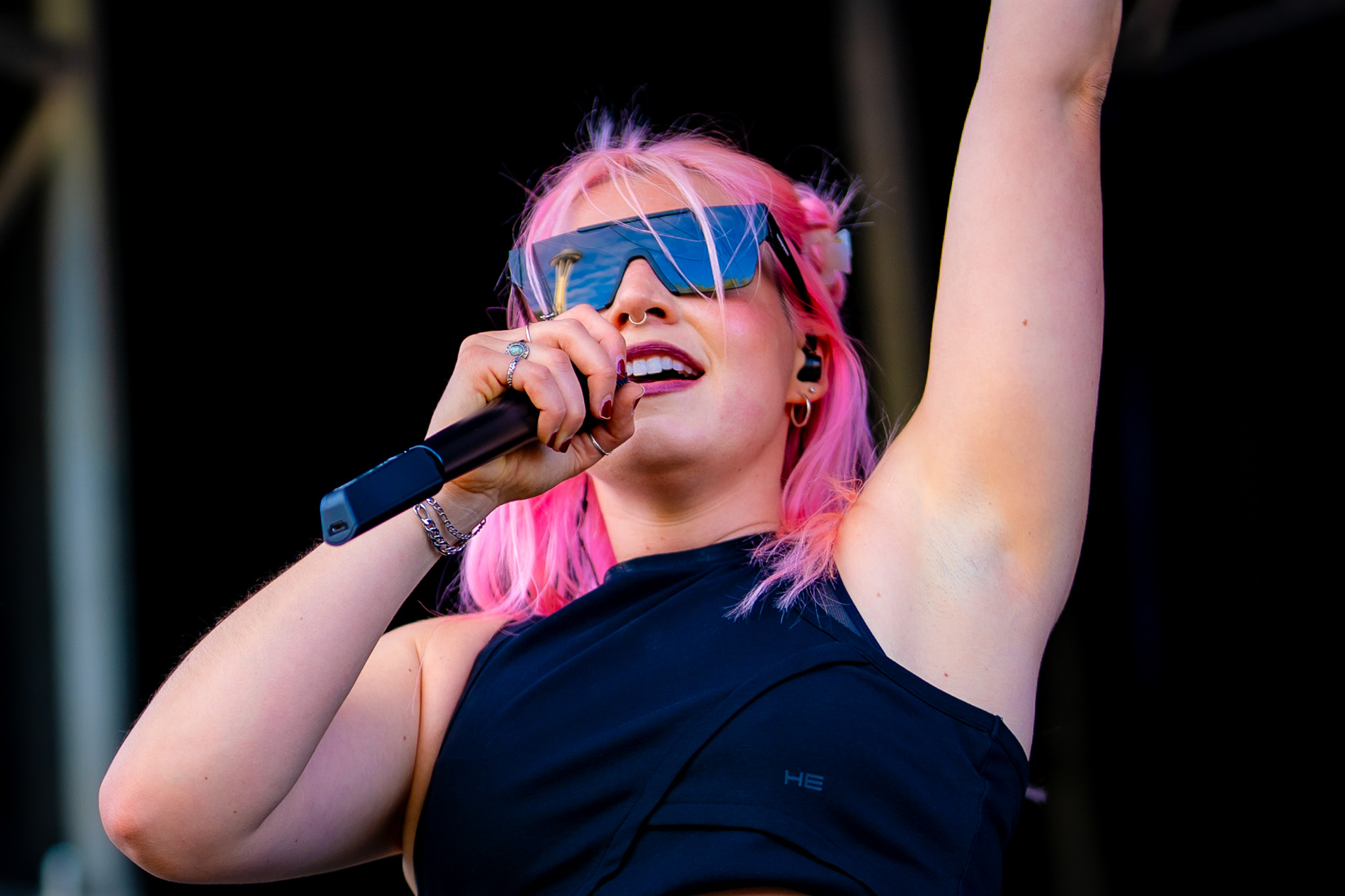 Pink-haired singer performing outdoors at Bite of Seattle