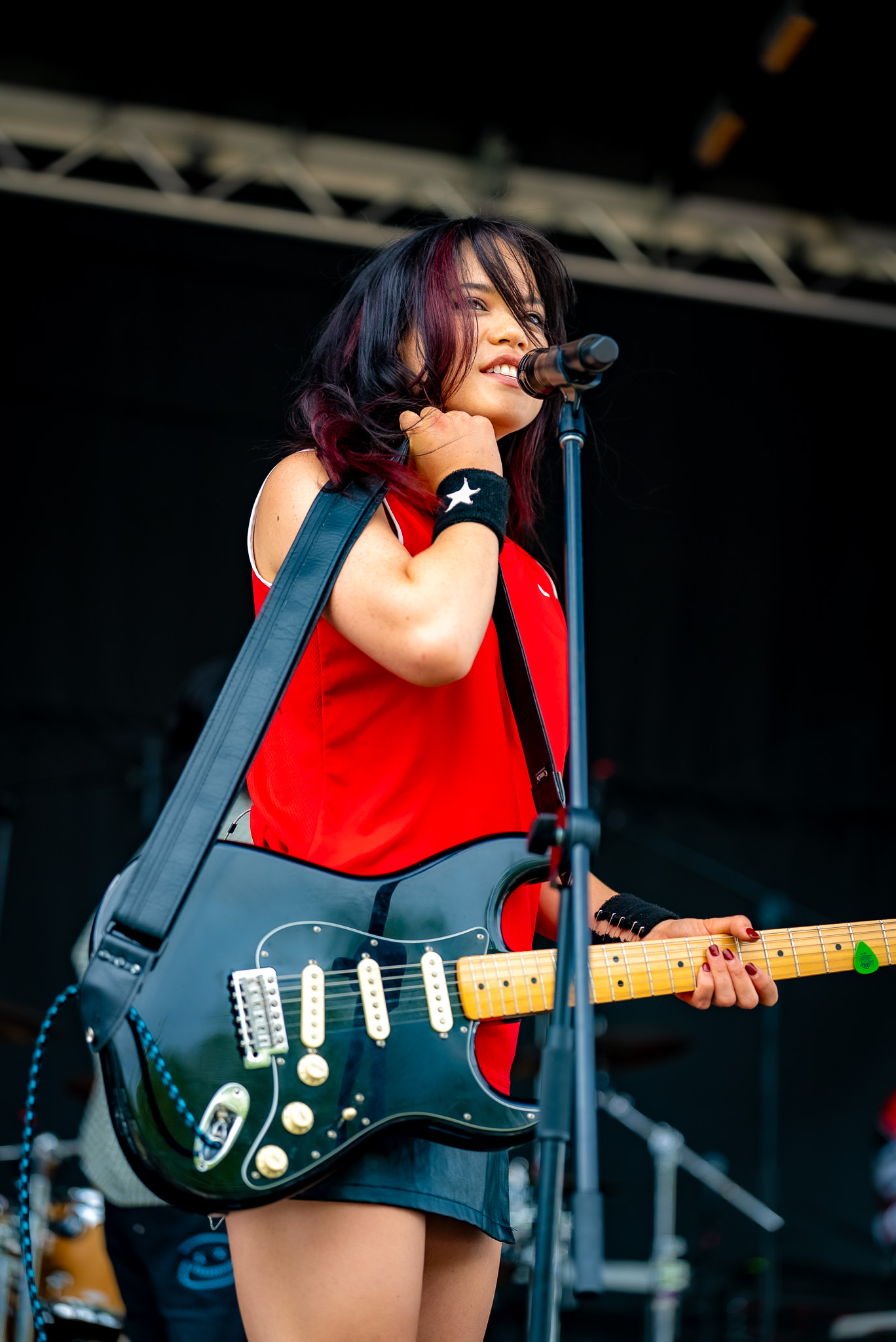 Guitarist and singer performing on an outdoor stage