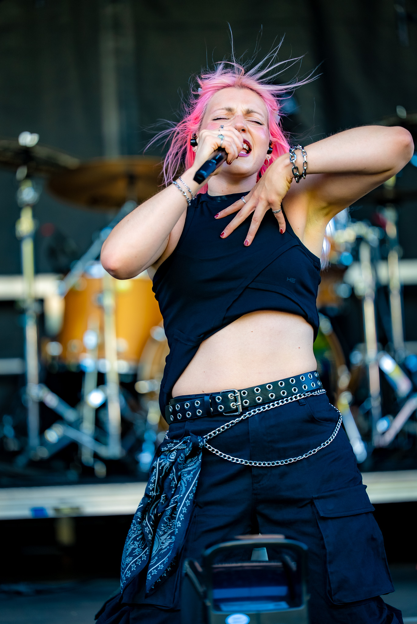 Vocalist singing under festival light