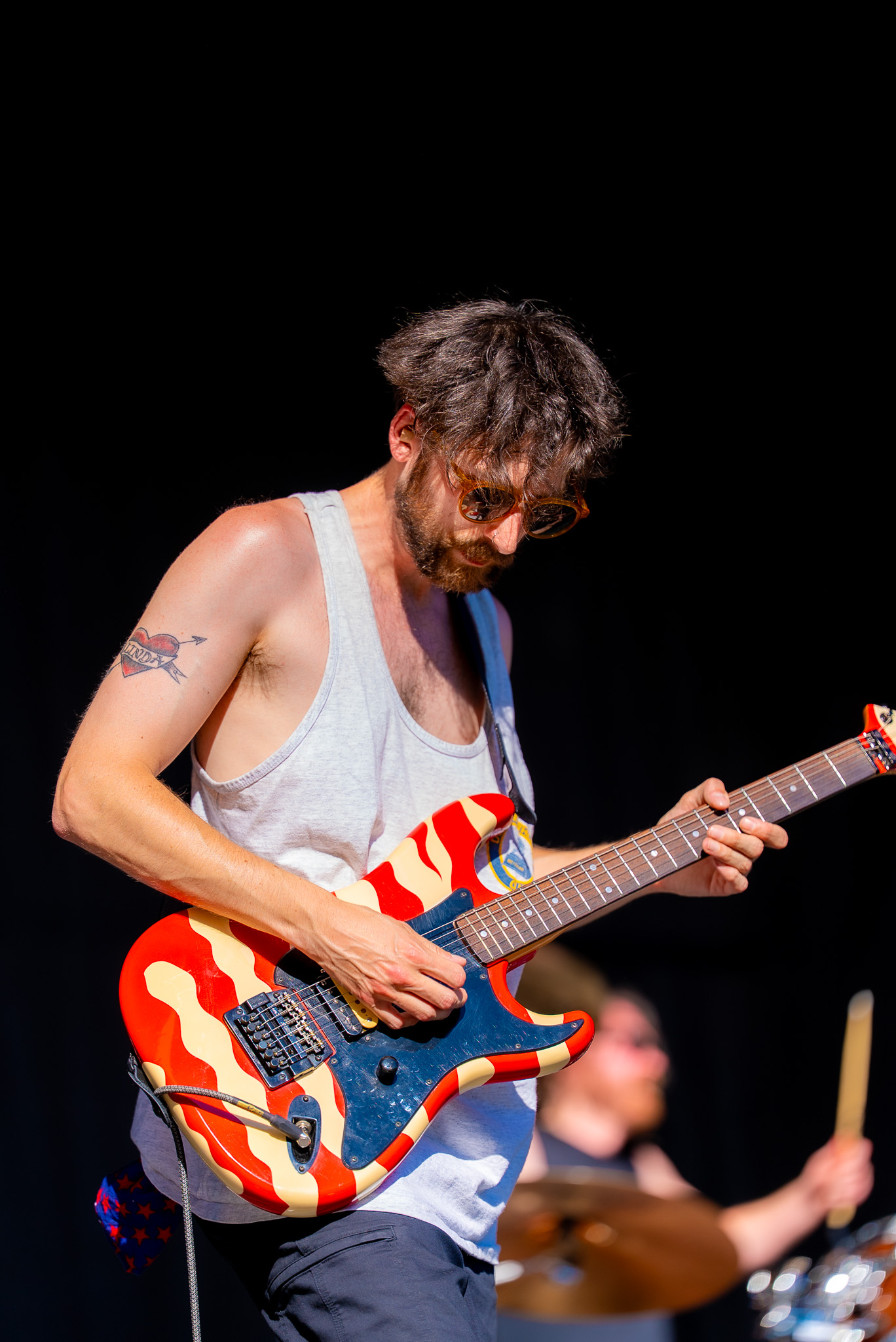 Guitarist playing against the festival stage