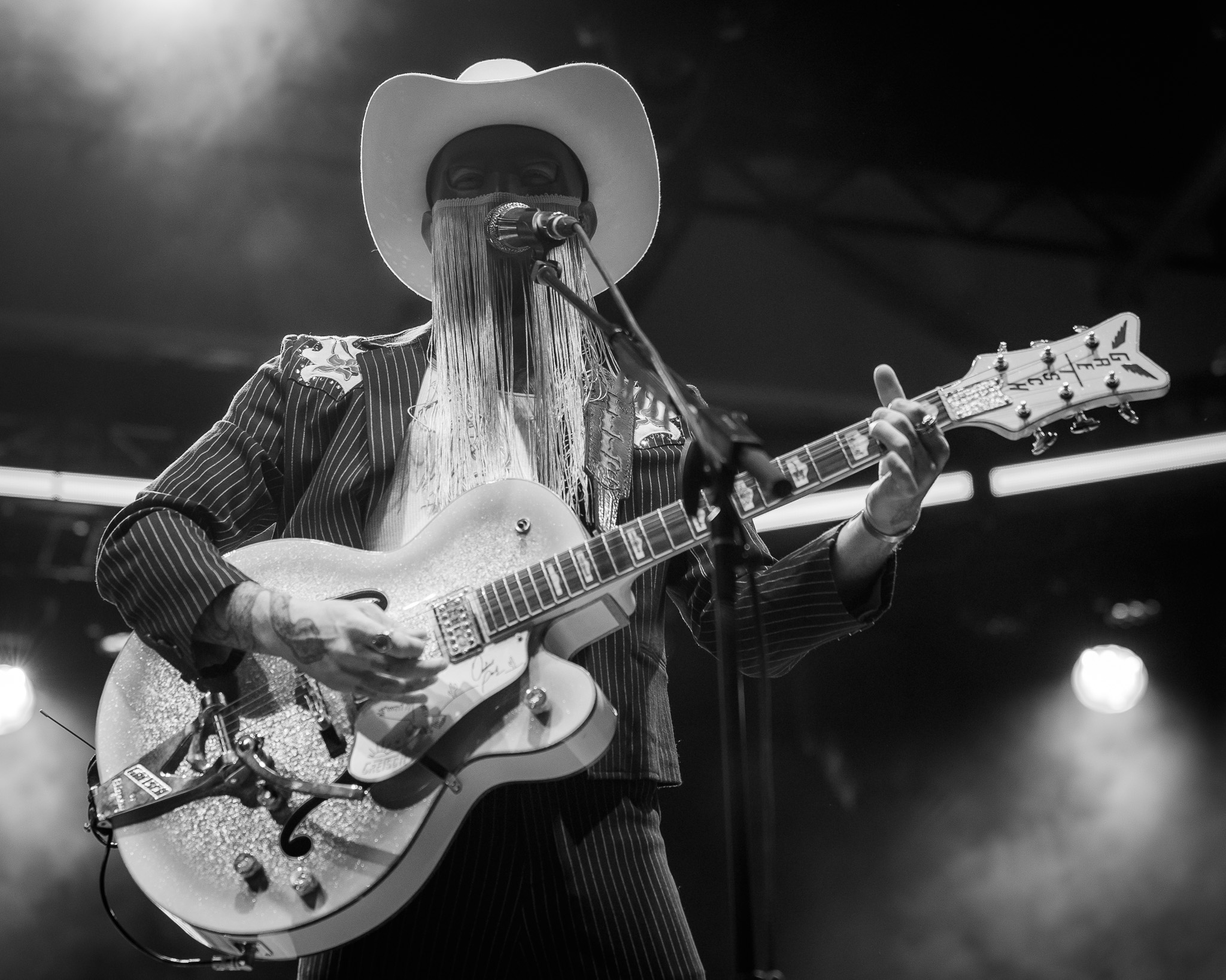 Orville Peck in a black-and-white guitar portrait
