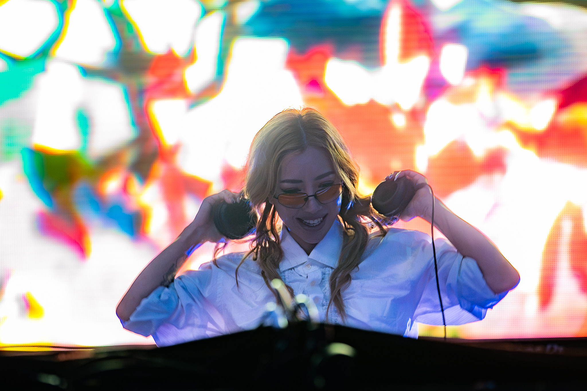 TOKiMONSTA performing against a bright wall of color