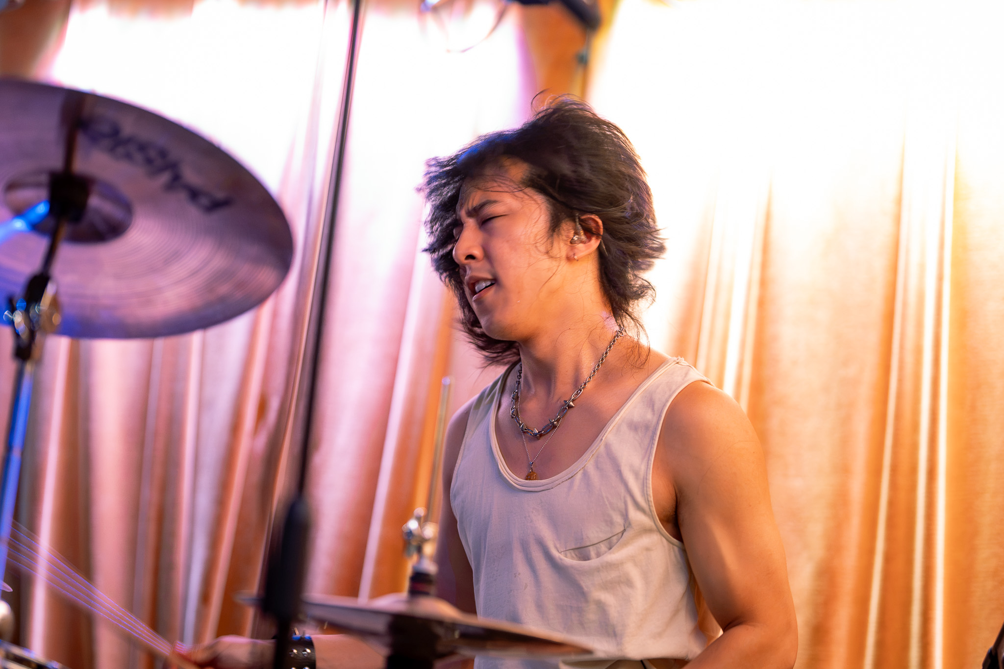 CHANPAN's drummer caught mid-strike behind a cymbal at Barboza