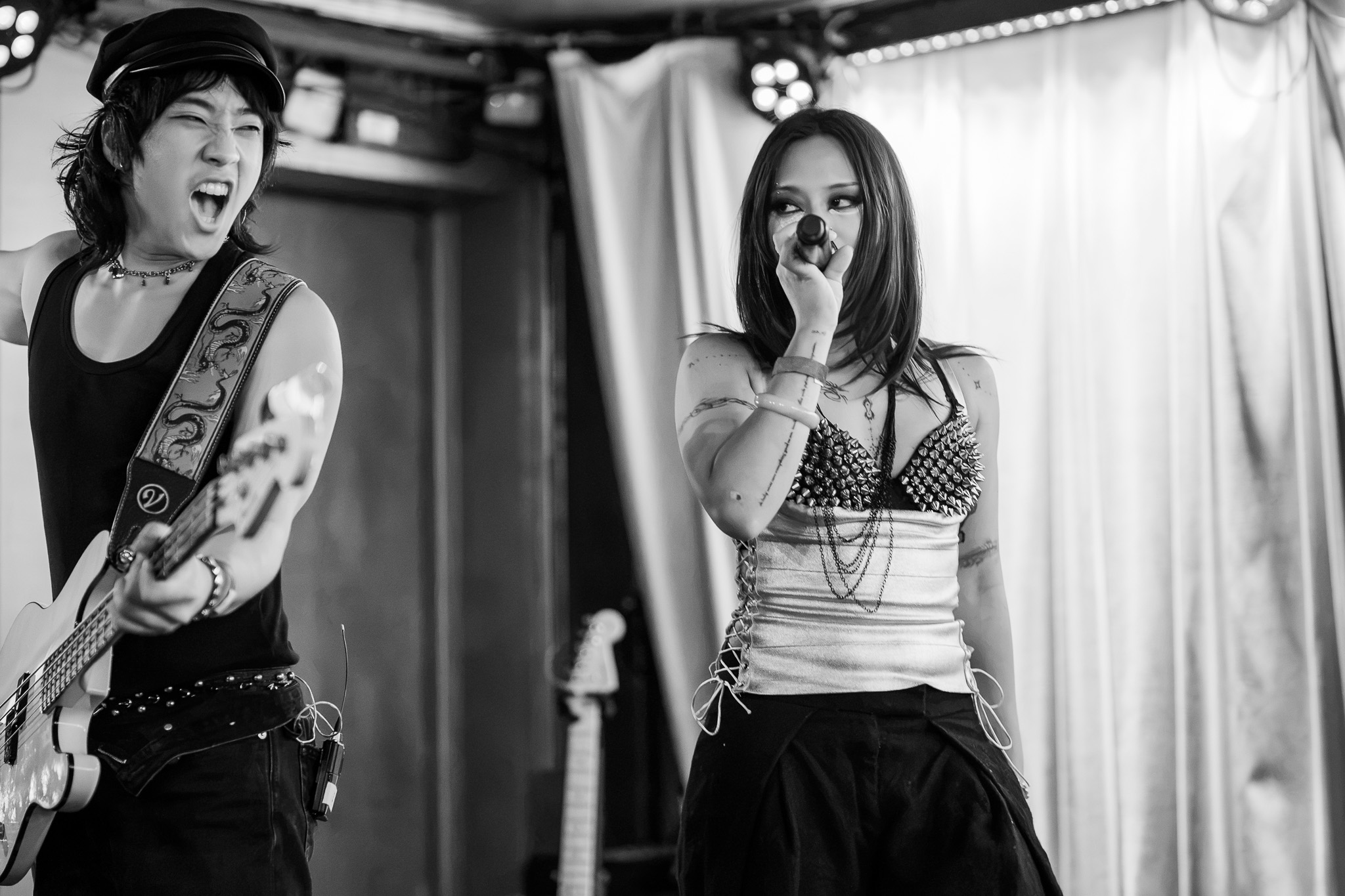 Two members of CHANPAN exchange expressions while performing at Barboza