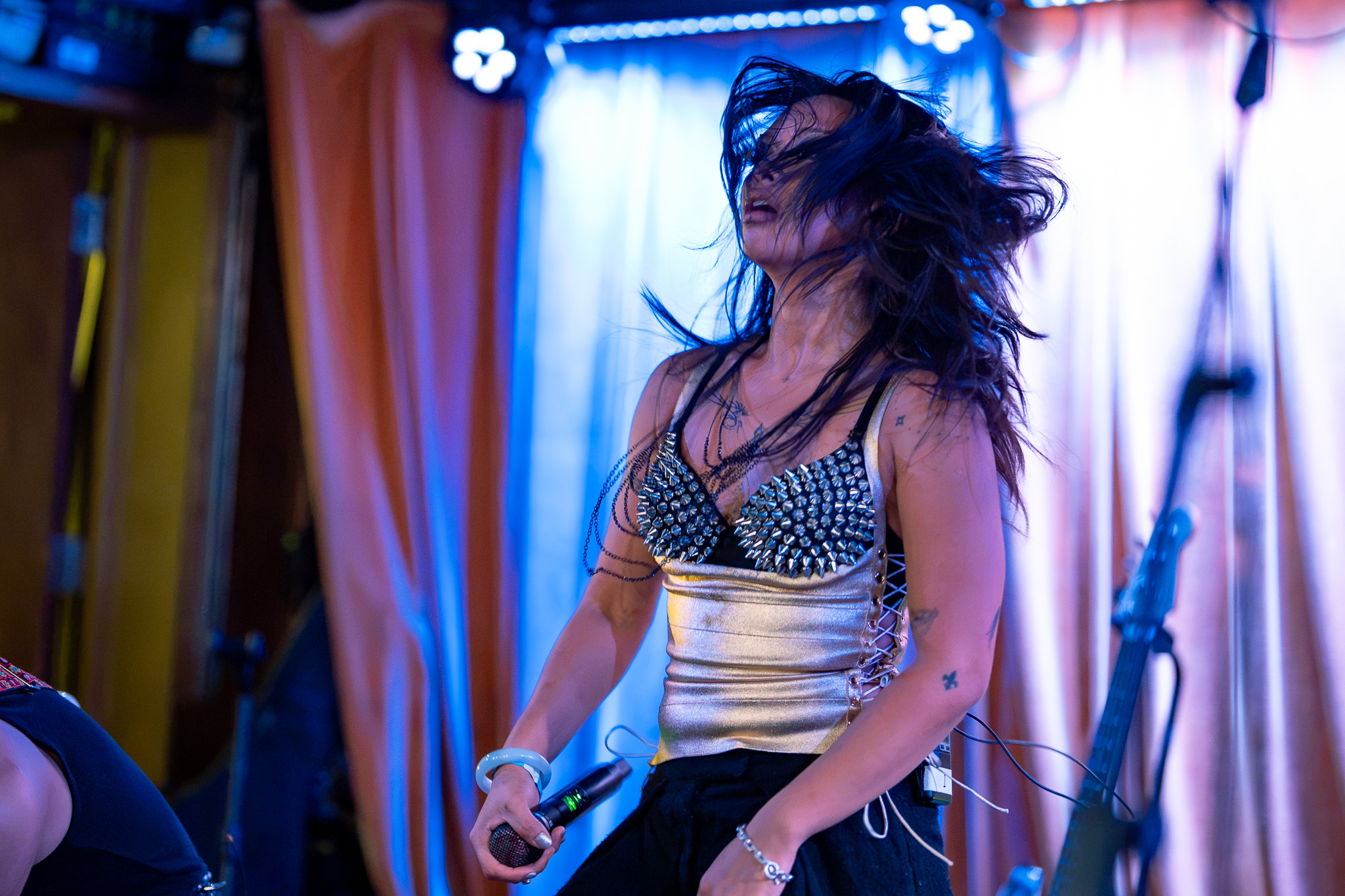 Grace Dumdaw throws her hair forward between vocals