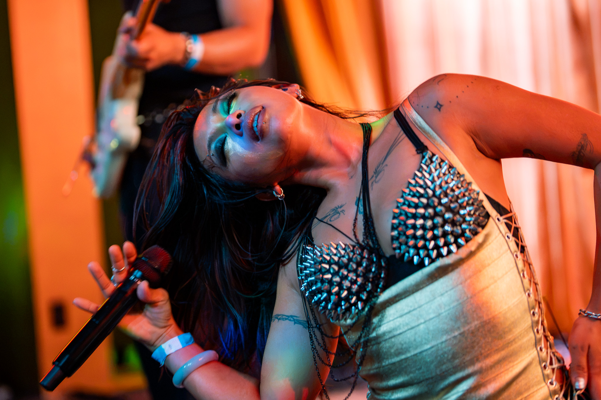 Grace Dumdaw bends backward at the microphone during CHANPAN's set