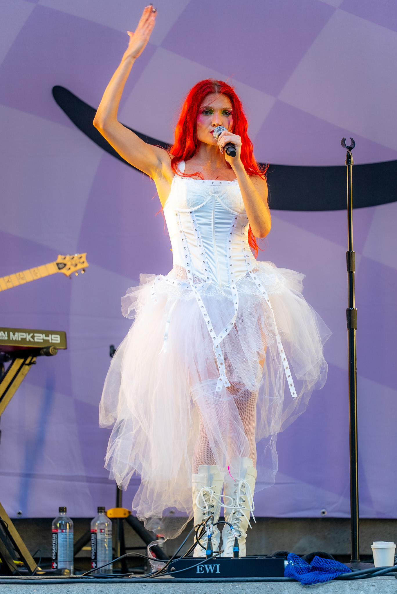 Cherry Bomb singing in a close vertical frame