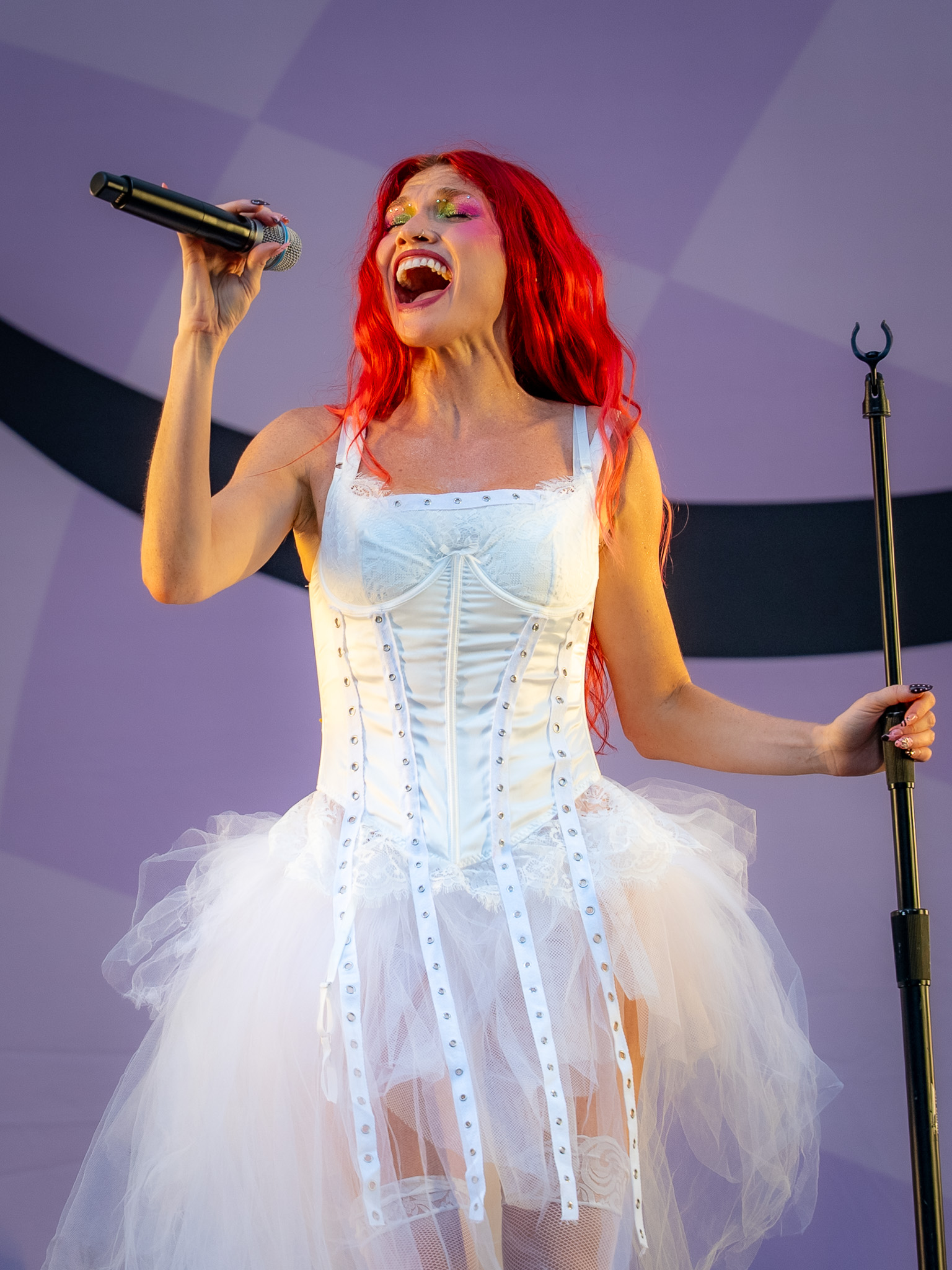 Cherry Bomb singing in white lace and tulle