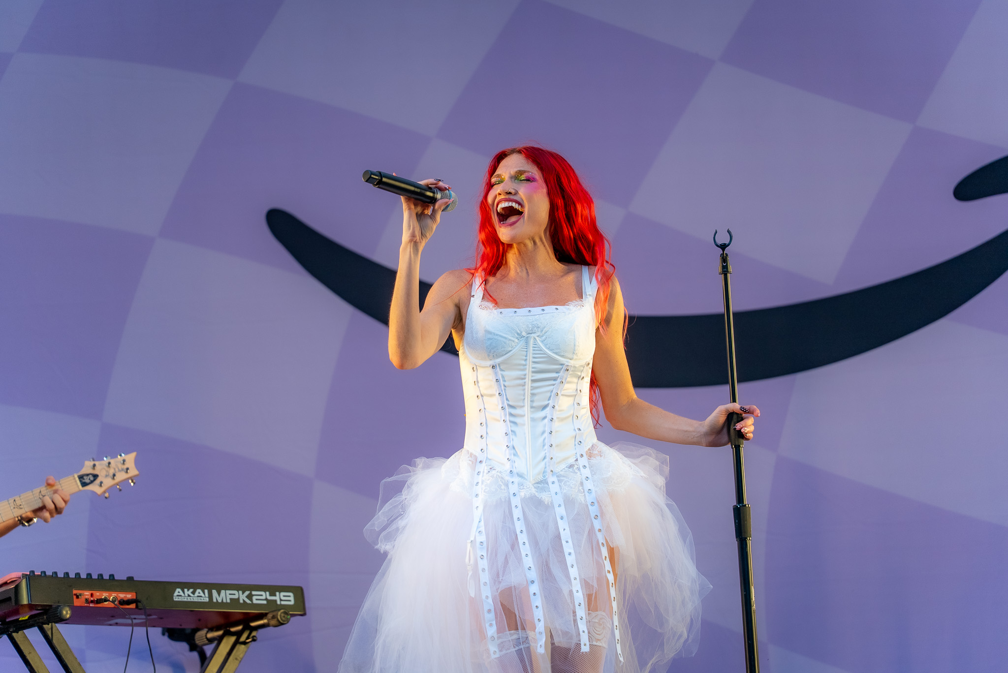 Cherry Bomb singing beneath lavender light