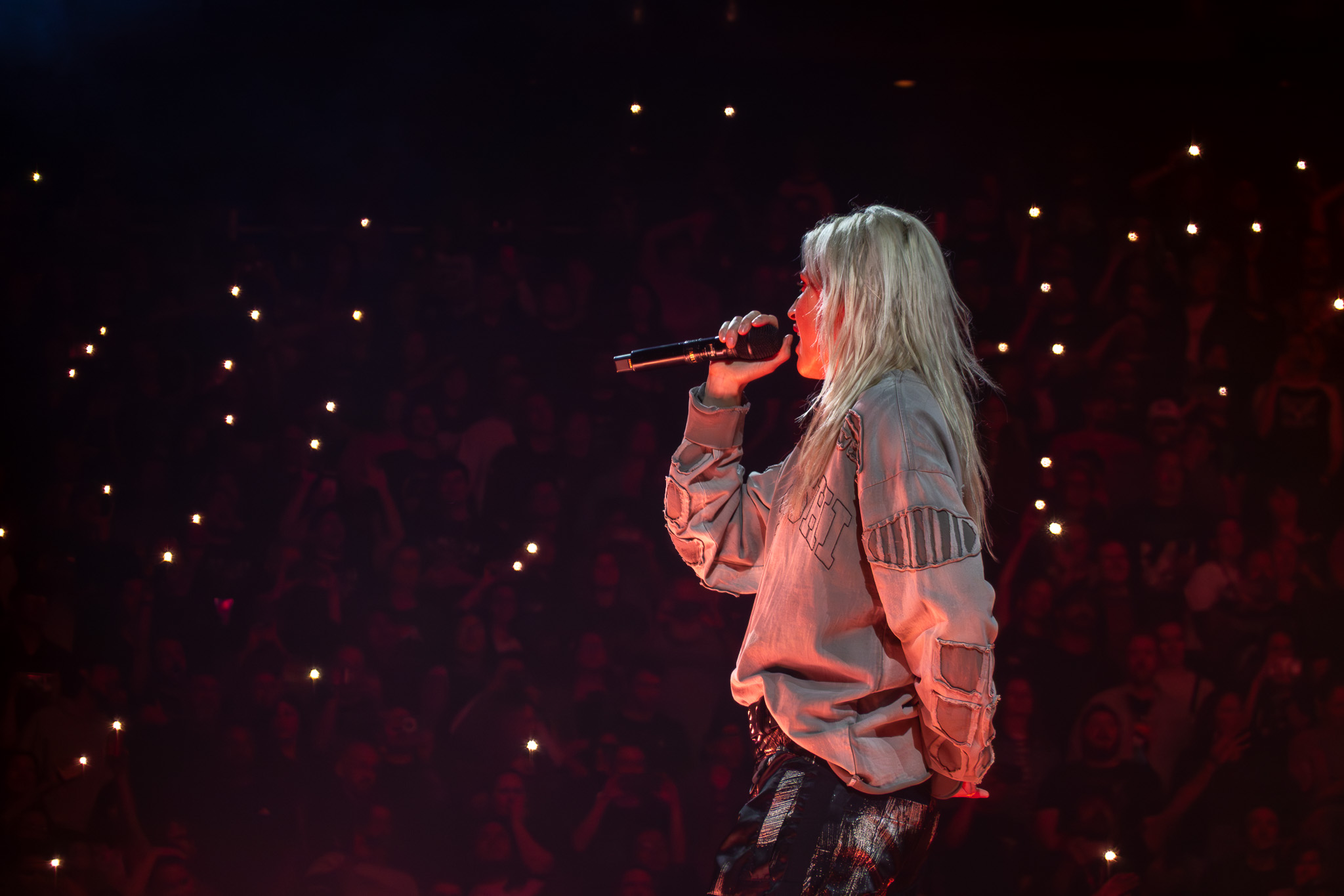Emily Armstrong performing against the Seattle crowd lights