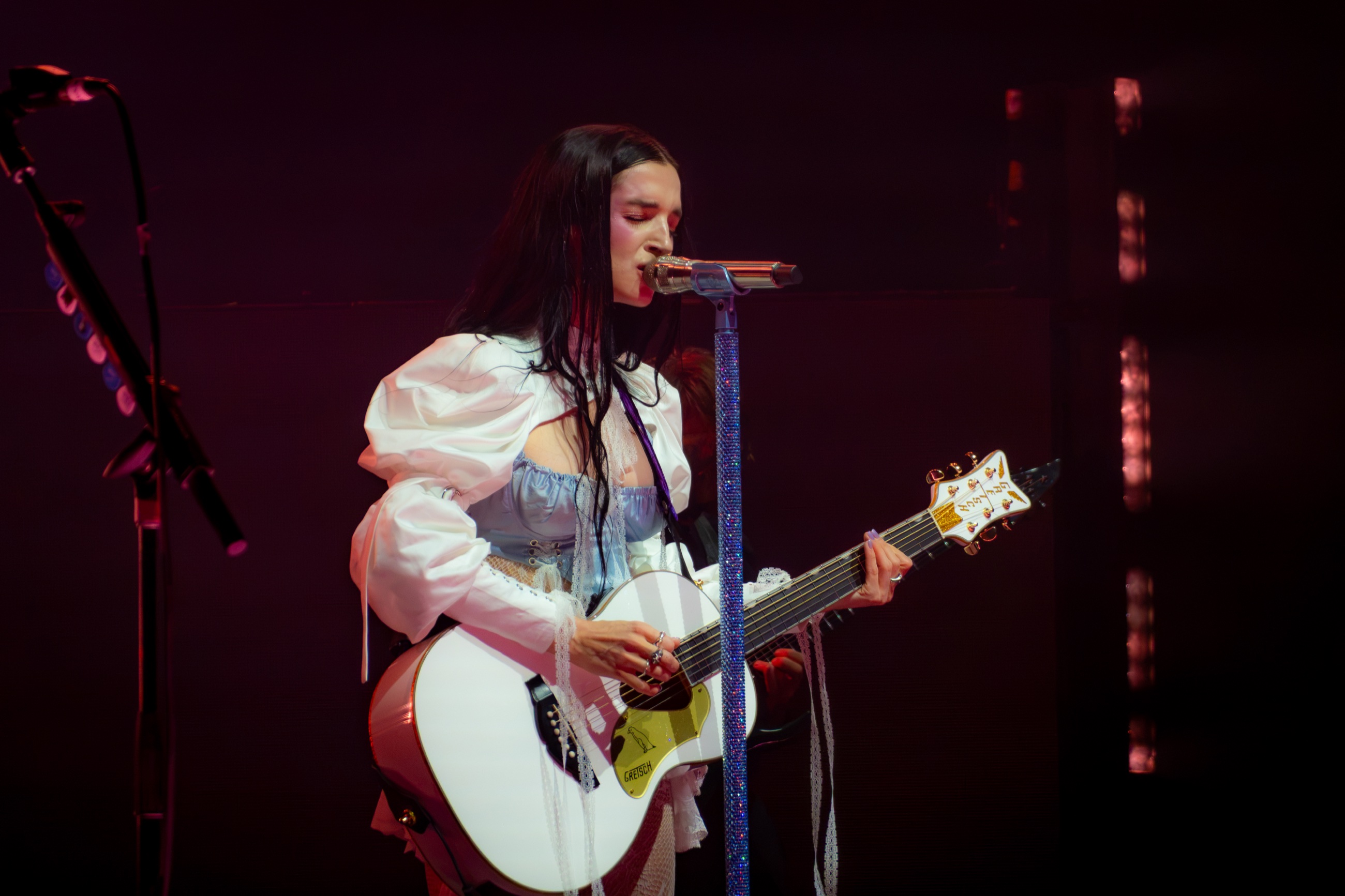 Poppy performing with a white guitar at the Paramount Theatre