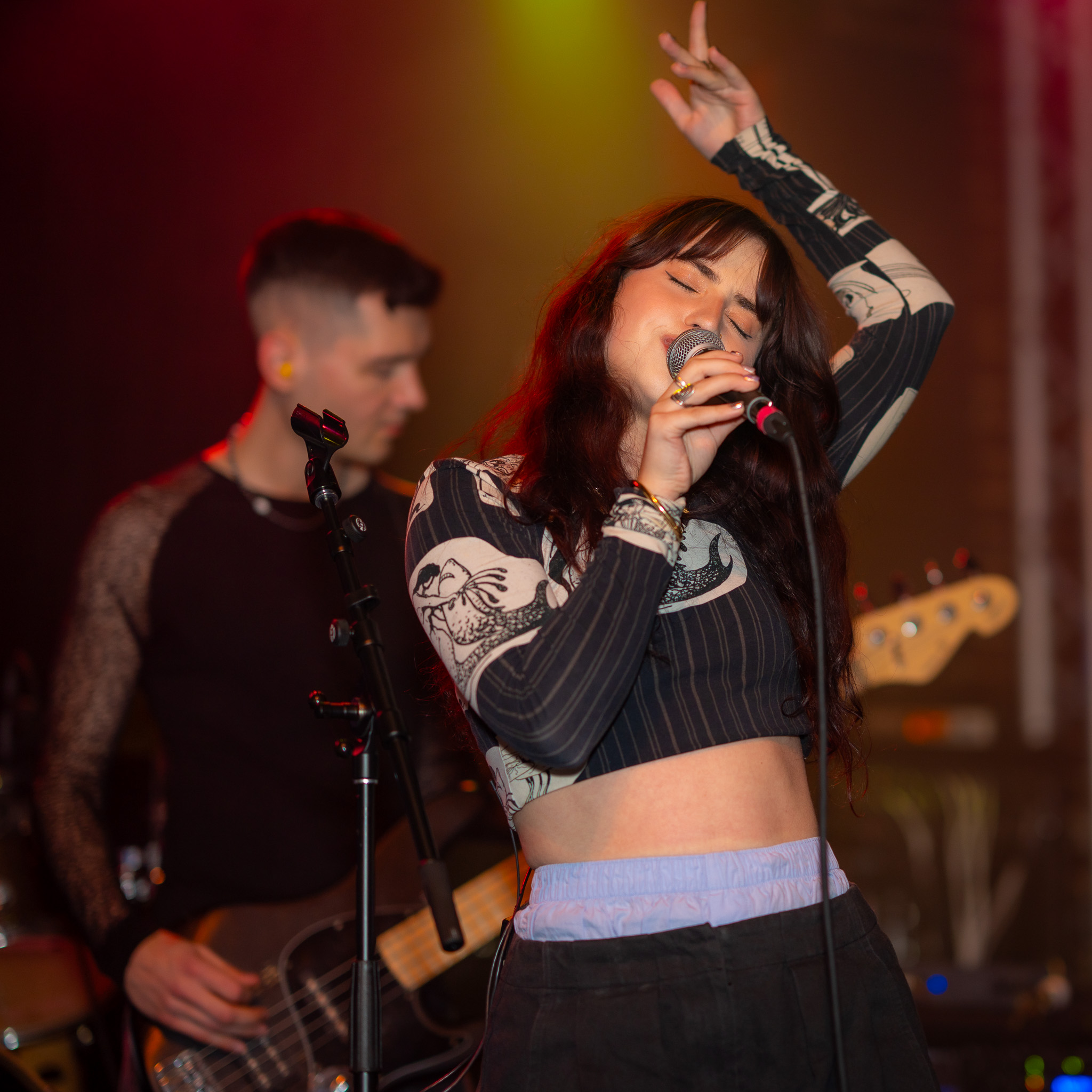 Waltzerr vocalist under saturated club light