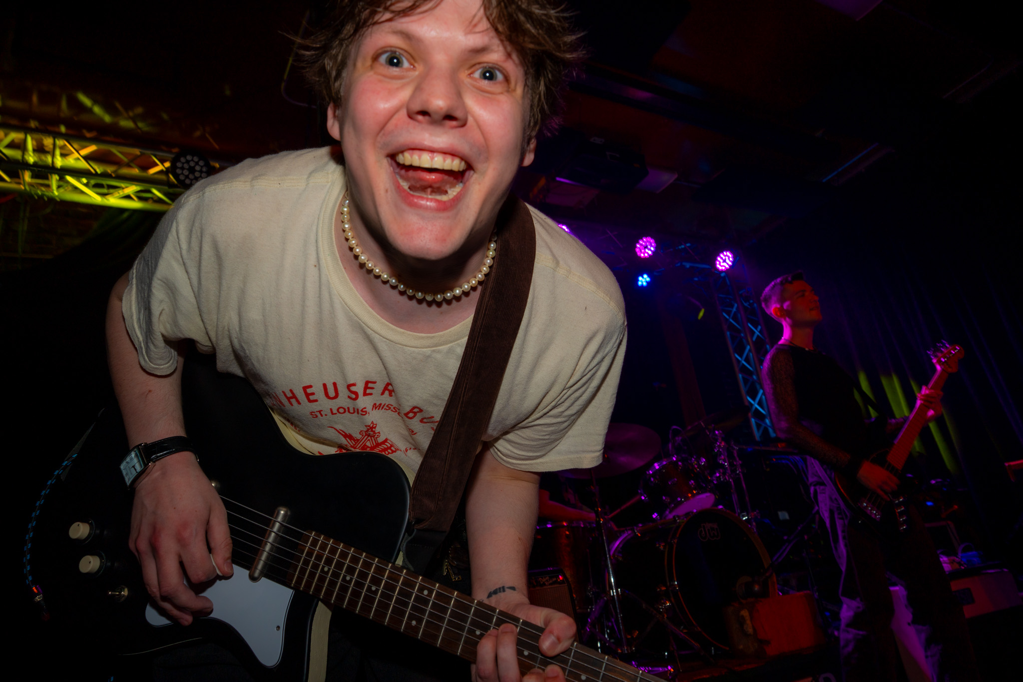 Waltzerr guitarist leaning playfully toward the camera