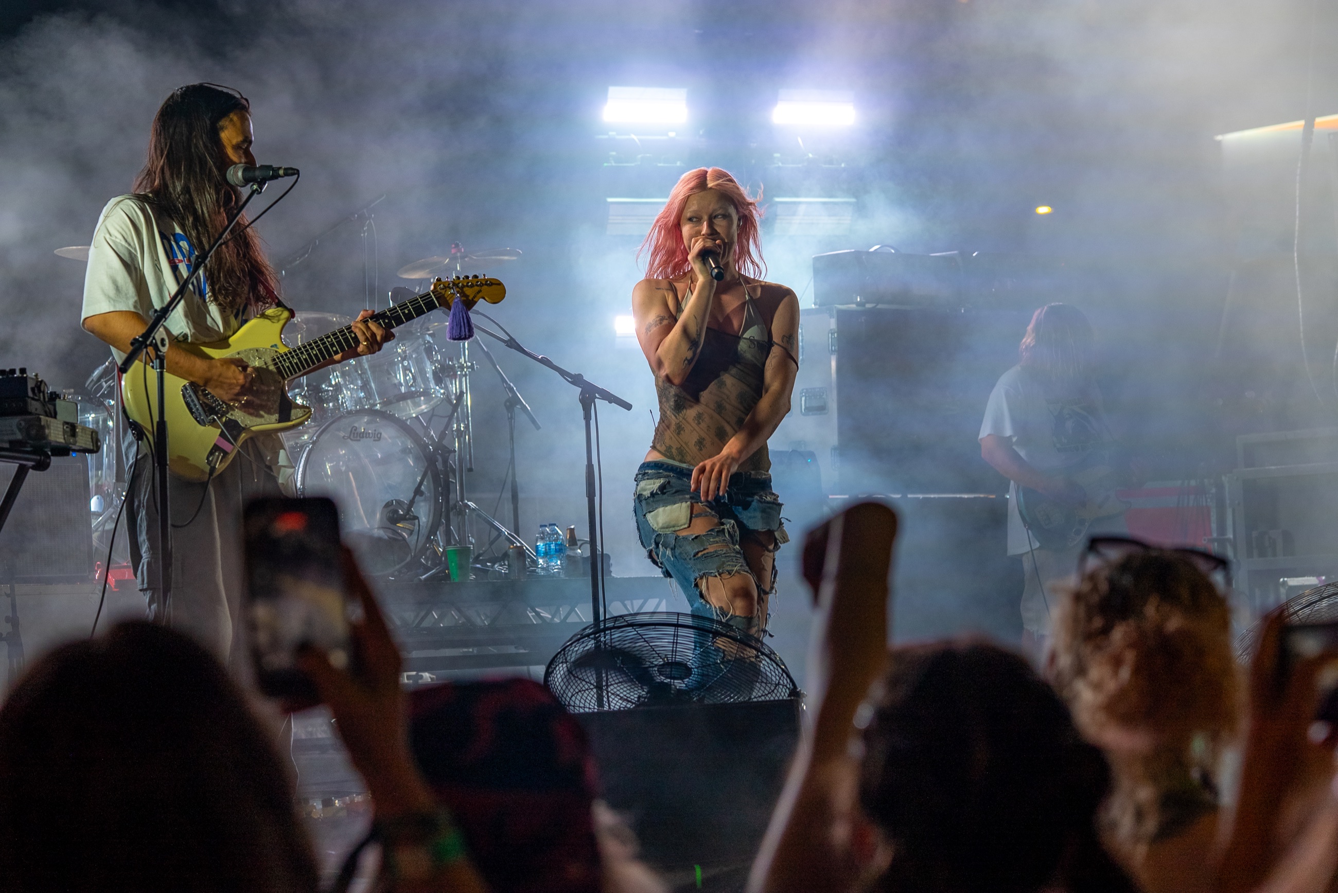Wide view of Wet Leg performing above a packed festival crowd