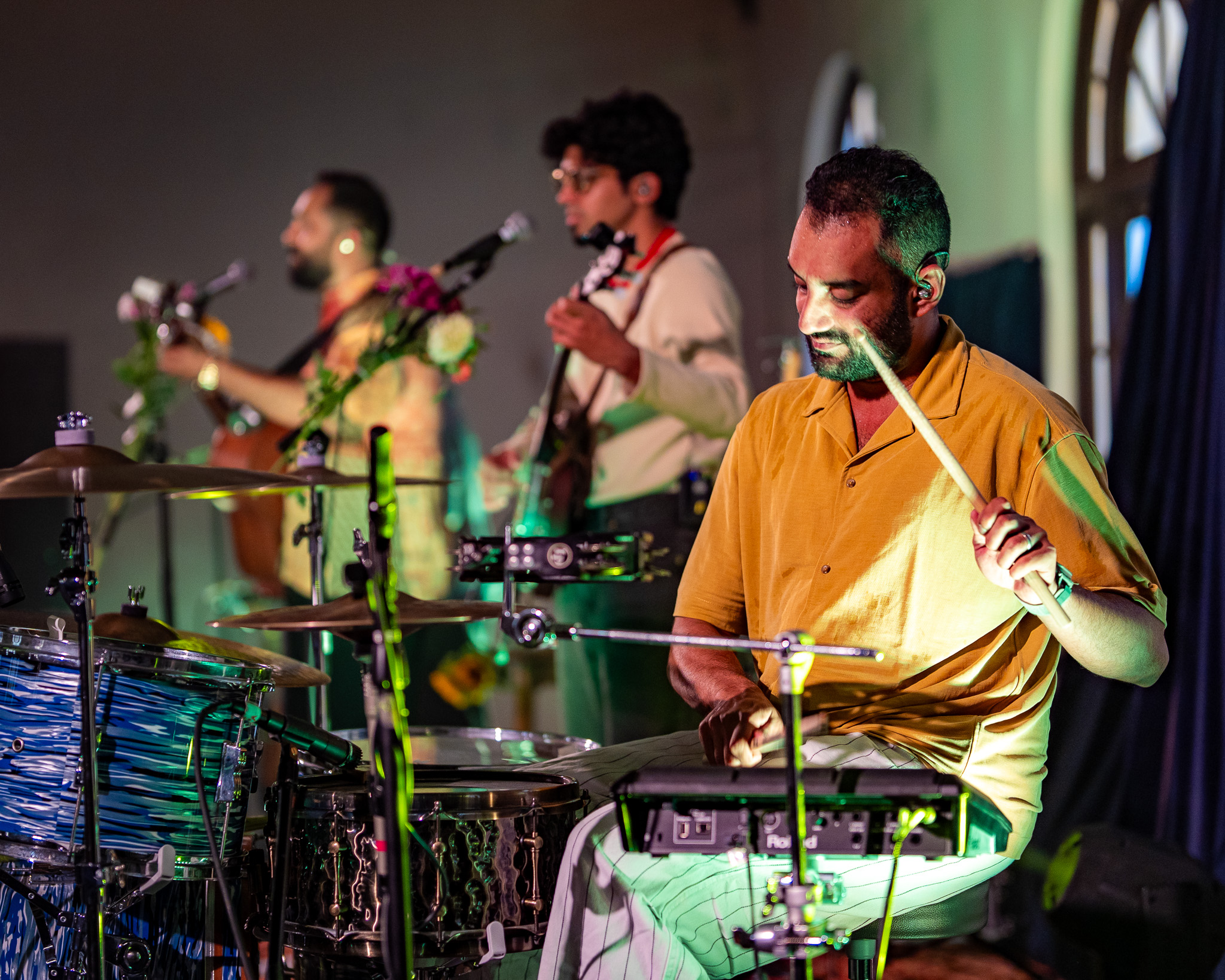 The drummer plays in the foreground with the rest of When Chai Met Toast behind him