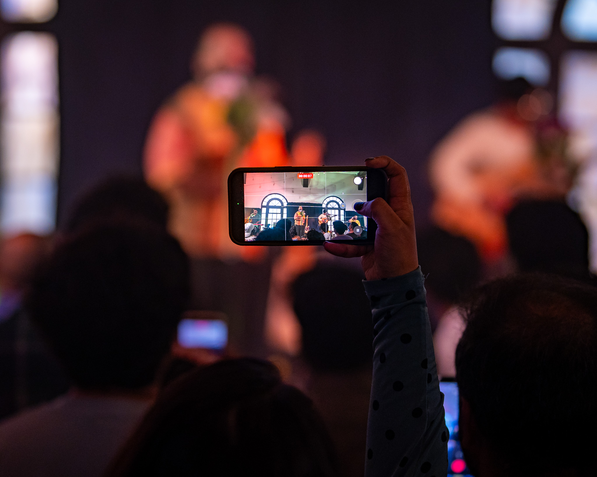 A concertgoer records When Chai Met Toast from the Fremont Abbey crowd